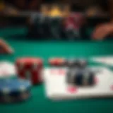 A close-up view of poker chips and a single deck of cards on a green felt table